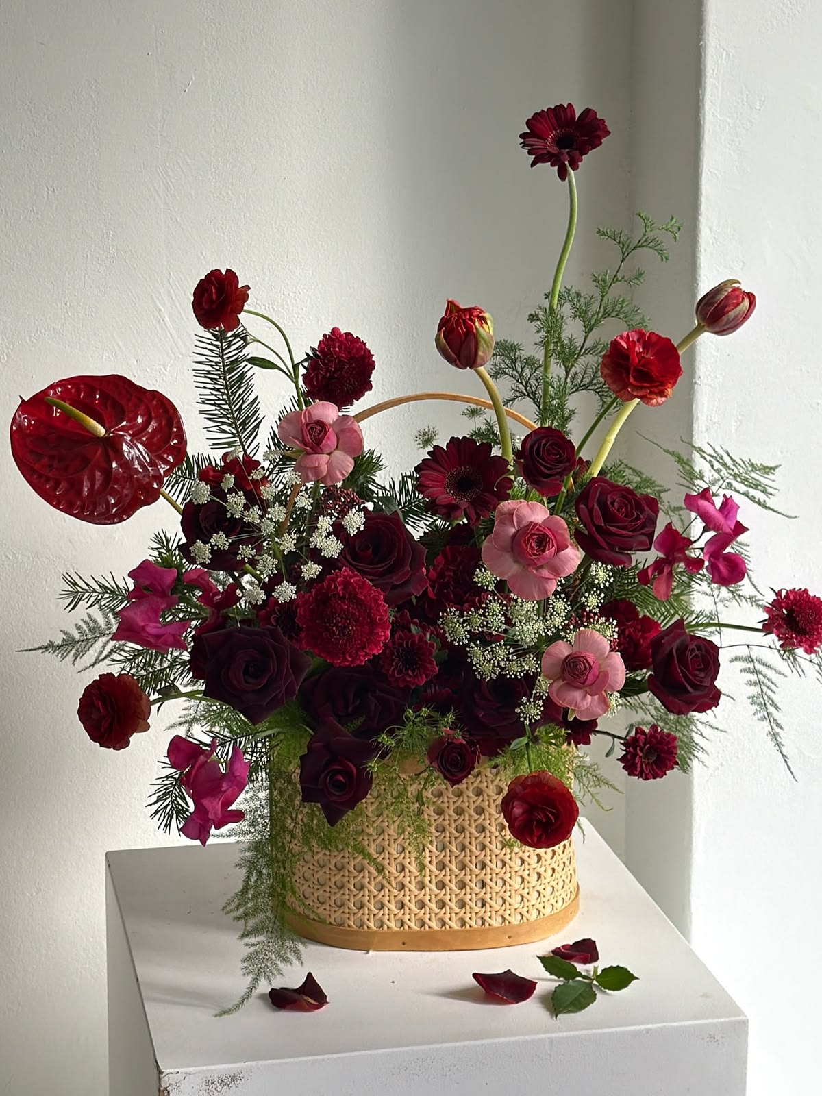 Lush burgundy arrangement in a wicker basket